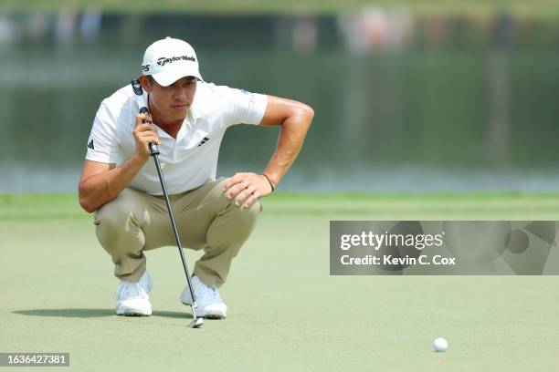 Collin Morikawa of the United States lines up a putt on the 15th green during the first round of the TOUR Championship at East Lake Golf Club on...