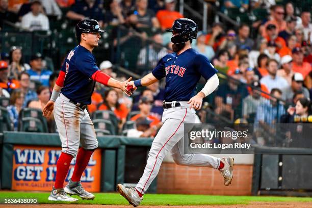 Connor Wong of the Boston Red Sox scores int he third inning against the Houston Astros at Minute Maid Park on August 24, 2023 in Houston, Texas.