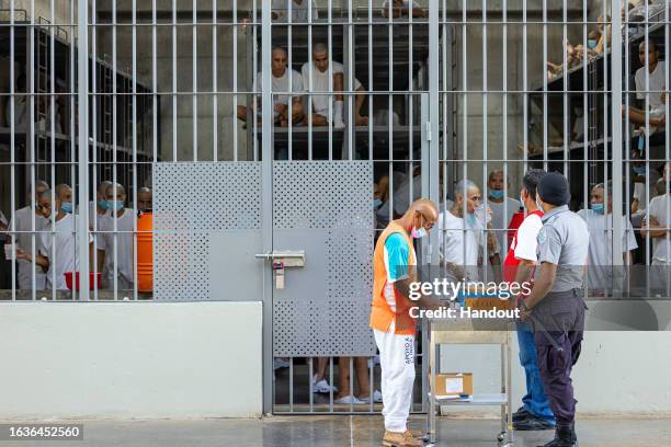 In this handout picture provided by the Salvadoran presidency An inmate receives medicine during a humanitarian visit to counter-terrorism...