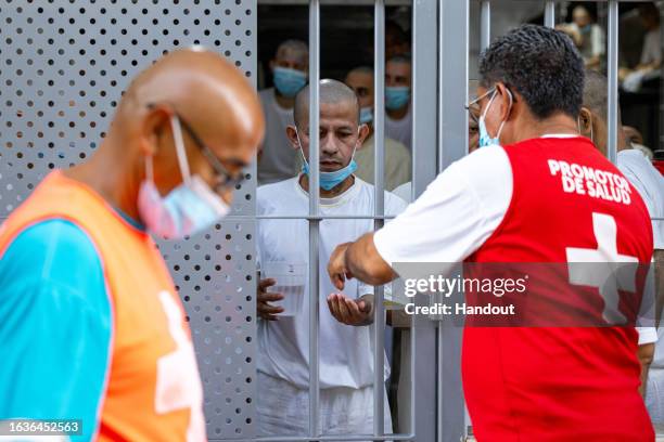 In this handout picture provided by the Salvadoran presidency An inmate receives medicine during a humanitarian visit to counter-terrorism...