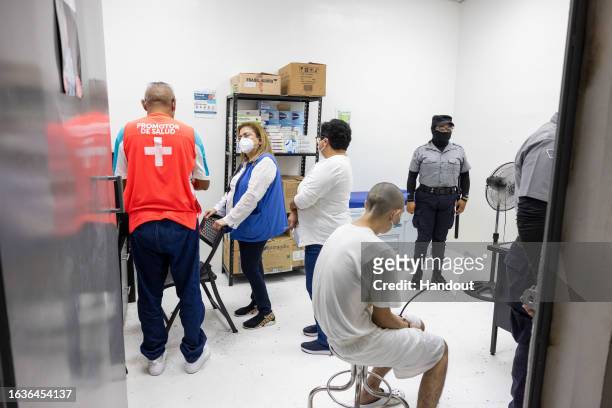 In this handout picture provided by the Salvadoran presidency An inmate receives medical attention during a humanitarian visit to counter-terrorism...