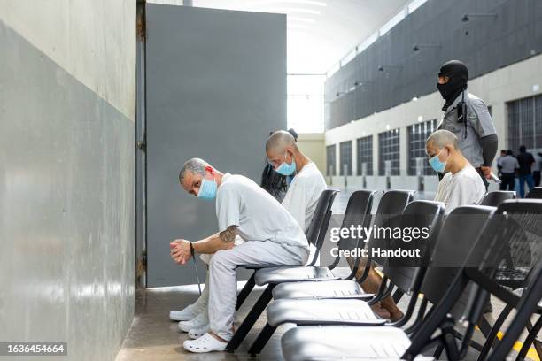 In this handout picture provided by the Salvadoran presidency Inmates await for medical attention during a humanitarian visit to counter-terrorism...