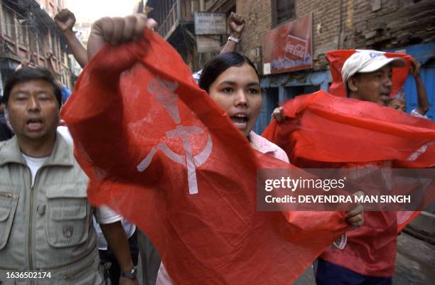 Nepalese political activists carrying hammer and sickel flags shout slogans during a protest rally in Kathmandu, 07 April 2006, on the second day of...
