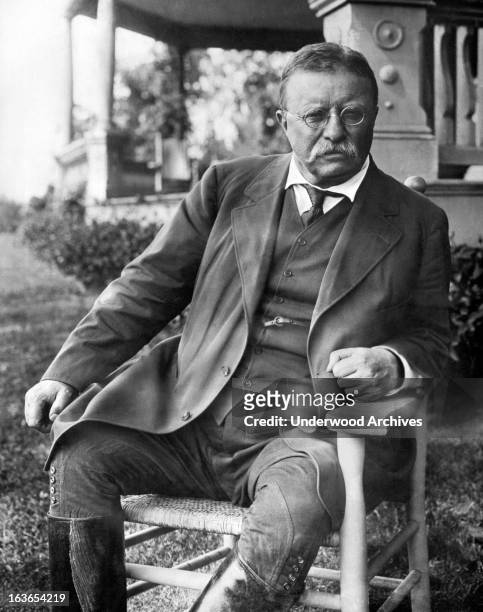 President Theodore Roosevelt seated in a chair outside his Sagamore Hill home on Long Island, Cove Neck, New York, circa 1907.