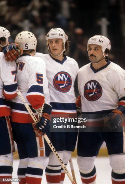Mike Bossy, Bryan Trottier, Denis Potvin and Stefan Persson of the New York Islanders celebrate during an NHL game in 1980 at the Nassau Coliseum in...
