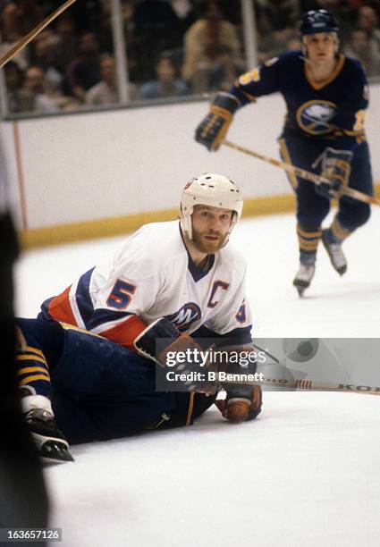 Denis Potvin of the New York Islanders battles with a player from the Buffalo Sabres during the 1980 Semi Finals in May, 1980 at the Nassau Coliseum...