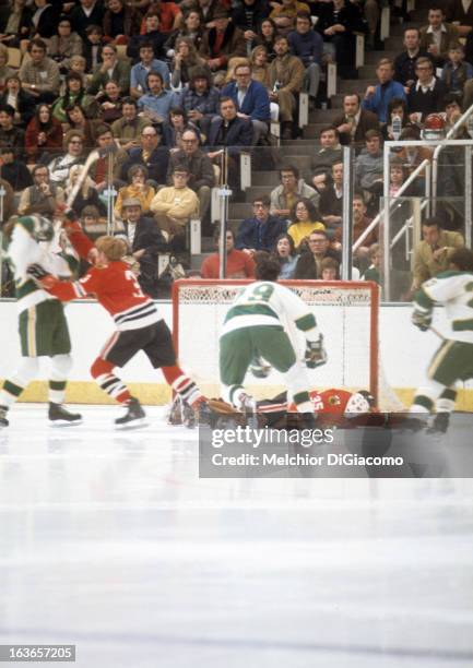 Goalie Tony Esposito of the Chicago Blackhawks makes the save on Dean Prentice of the Minnesota North Stars on March 5, 1972 at the Met Center in...