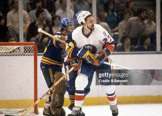 John Tonelli of the New York Islanders battles with goalie Bob Sauve and Bill Hajt of the Buffalo Sabres during the 1980 Semi Finals in May, 1980 at...