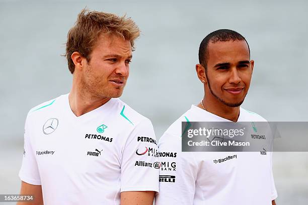 Nico Rosberg of Germany and Mercedes GP and team mate Lewis Hamilton of Great Britain and Mercedes GP pose for photographers at an event on St Kilda...