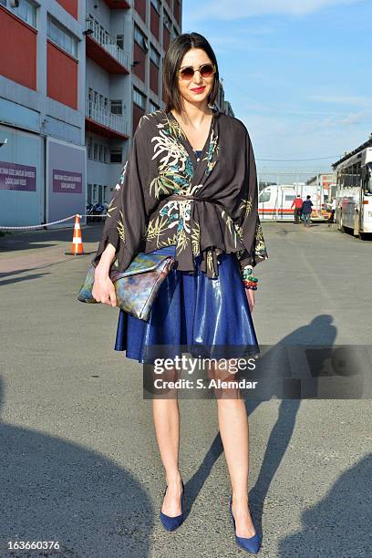 Fashion week guest wearing American Apparel dress, H&M bag and Zara coat is seen during Mercedes-Benz Fashion Week Istanbul Fall/Winter 2013/14 at...