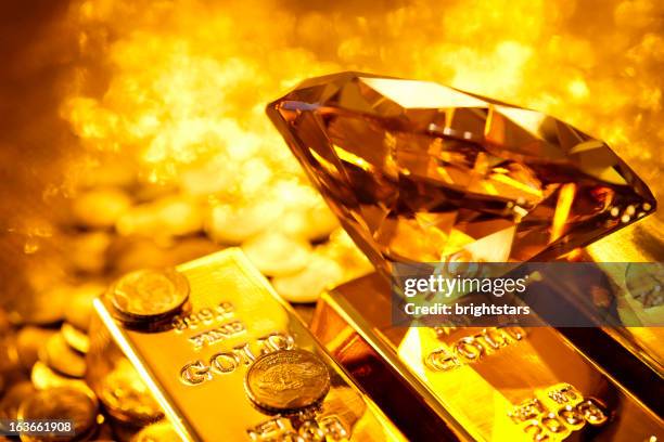 amber diamond auf gold bars - gold bars stock-fotos und bilder