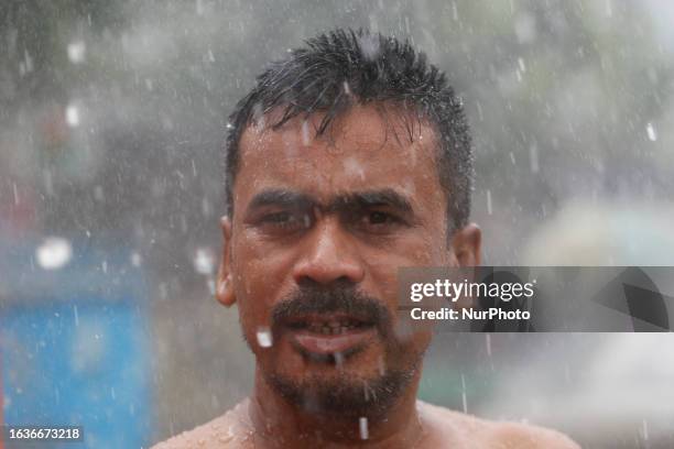 Man wet in the rain in Dhaka, Bangladesh on August 31, 2023.