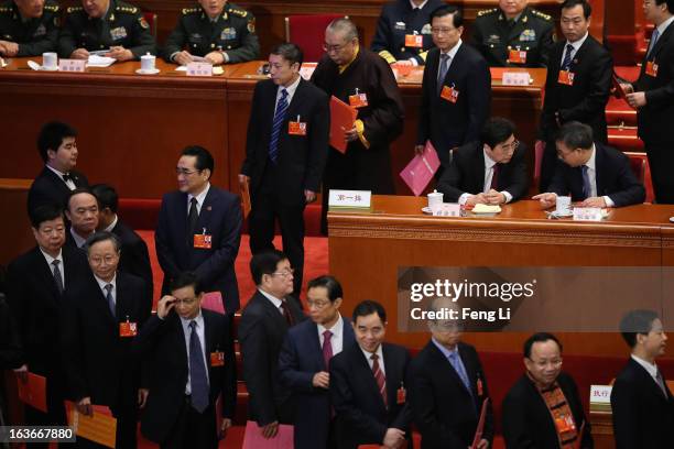 Guangdong Communist Party Secretary Hu Chunhua talks with Beijing Municipal Communist Party Secretary Guo Jinlong as delegates waiting to cast their...