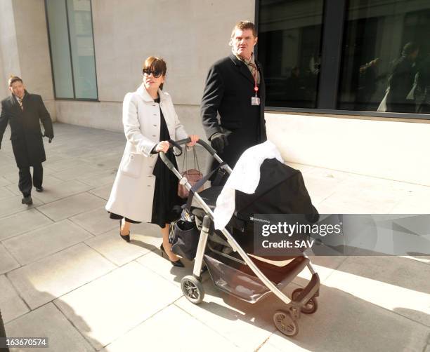 Lily Allen pushes her daughter Marnie Rose in a pram as she walks to Radio 1 for Comic Relief on March 14, 2013 in London, England.