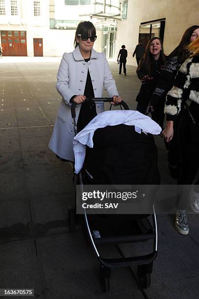 Lily Allen pushes her daughter Marnie Rose in a pram as she walks to Radio 1 for Comic Relief on March 14, 2013 in London, England.