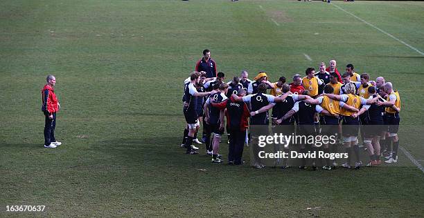 Stuart Lancaster, the England head coach looks on as his team gather during the England training session at Pennyhill Park on March 14, 2013 in...