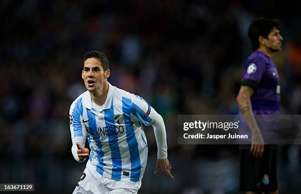 Isco of Malaga CF celebrates scoring his sides opening goal during the UEFA Champions League Round of 16 second leg match between Malaga CF and FC...