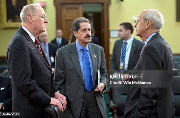 Supreme Court Associate Justices Anthony Kennedy and Stephen Breyer talk with Rep. Jose Serrano before the start of a hearing on Capitol Hill March...