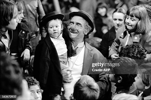 An archive photo taken on November 8, 1976 in Paris shows French clown and circus operator Achille Zavatta holding his son Franck at the end of his...