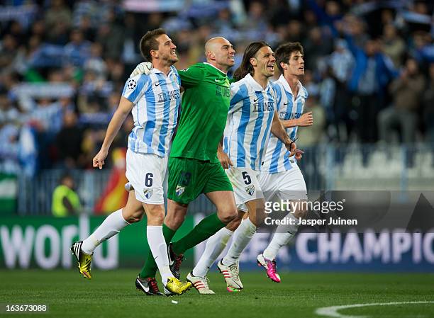 Ignacio Camacho, goalkeeper Willy Caballero, Martin Demichelis and Lucas Piazon of Malaga CF celebrate at the end of the UEFA Champions League Round...
