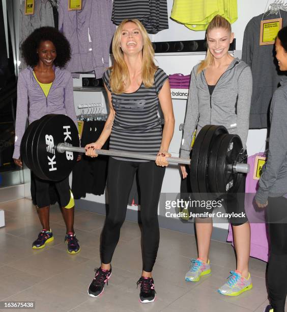 Actress Model Heidi Klum poses with models wearing her new clothing line during the Heidi Klum For New Balance Collection Launch at Lady Foot Locker...