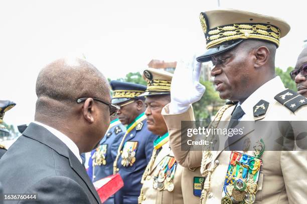 Head of Gabon's elite Republican Guard, General Brice Oligui Nguema , is decorated by Gabon Prime Minister Alain Claude Bilie Bie Nze in Libreville...