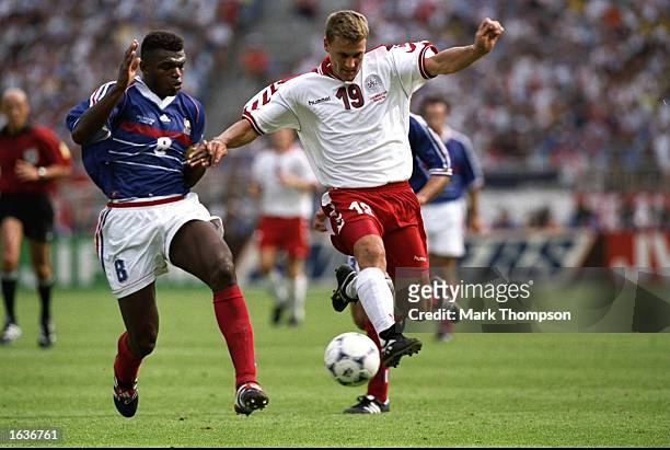 Ebbe Sand of Denmark takes on Marcel Desailly of France during the World Cup group C game at the Stade Gerland in Lyon, France. France won 2-1 to top...
