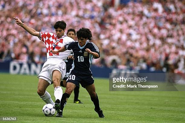 Aljosa Asanovic of Croatia challenges Ariel Ortega of Argentina during the World Cup group H game at the Parc Lescure in Bordeaux, France. Argentina...
