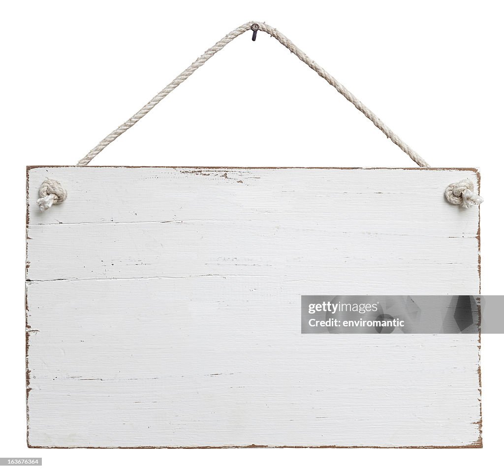 Old, white weathered signboard hanging by a string