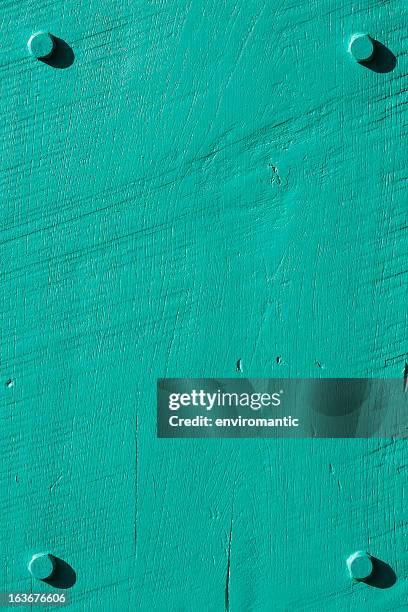 turquoise grunge wood background with four bolts. - groenhout stockfoto's en -beelden