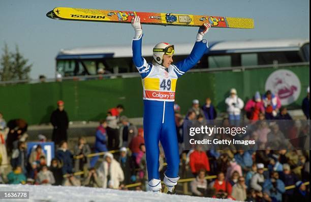 Matti Nykanen of Finland holds his skies aloft after the 90 metres Ski Jump event at the 1988 Winter Olympic Games in Calgary, Canada. Nykanen won...