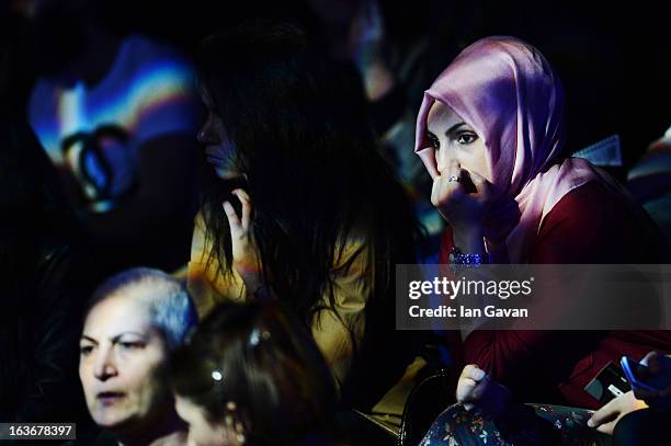 Guests attend the Mercedes-Benz Presents Ozlem Kaya show during Mercedes-Benz Fashion Week Istanbul Fall/Winter 2013/14 at Antrepo 3 on March 14,...