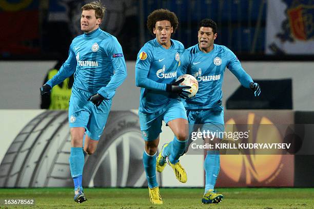 Zenit St. Petersburg's football players Axel Witsel , Nicolas Lombaerts and Hulk celebrate scoring a goal during UEFA Europe League round of 16...