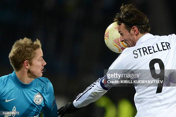 Zenit St. Petersburg's football player Tomas Hubocan fights for a ball with FC Basel 1893's player Marco Streller during their UEFA Europe League...