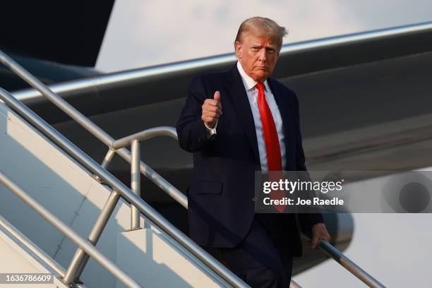 Former U.S. President Donald Trump gives a thumbs up as he arrives at Atlanta Hartsfield-Jackson International Airport on August 24, 2023 in Atlanta,...