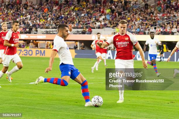 Ferrán Torres of Barcelona shoots the ball and scores a goal while Rob Holding of Arsenal defends before a game between Barcelona and Arsenal at SoFi...