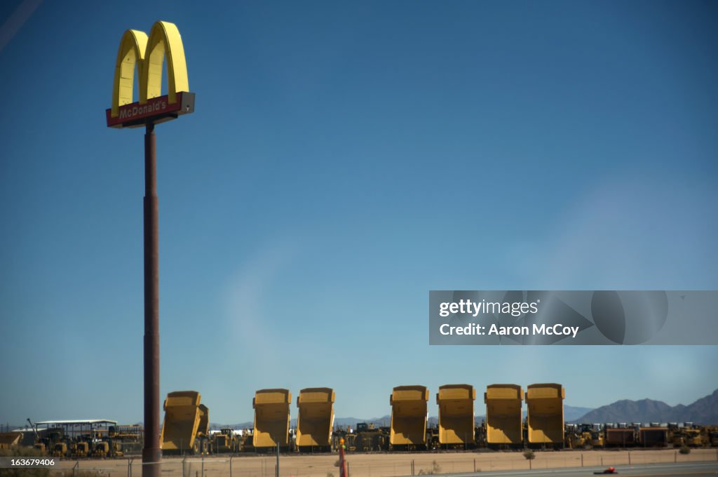 McDonald's sign next to dump trucks