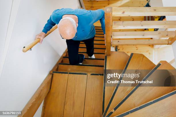 Symbolic photo on the topic of accident risk in the household. An old man is walking up a steep flight of stairs on August 31, 2023 in Berlin,...