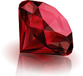A deep red ruby laying on its side