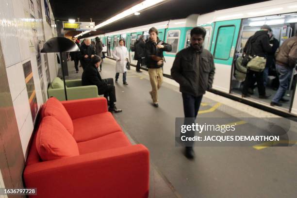 People walk past couches displayed by Swedish furniture giant Ikea on March 11, 2010 at the Concorde metro station. AFP PHOTO/JACQUES DEMARTHON