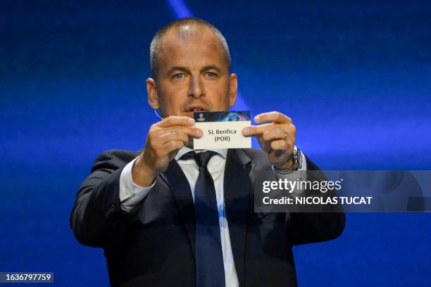 English former football player Joe Cole shows the paper slip of SL Benfica during the draw for the 2023/2024 UEFA Champions League football...