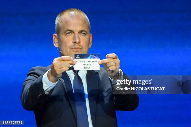 English former football player Joe Cole shows the paper slip of Inter Milan during the draw for the 2023/2024 UEFA Champions League football...