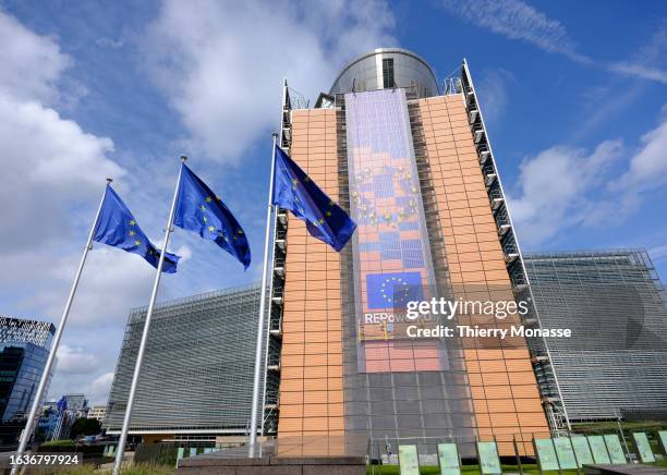 The flags of the European Union flutter in the winds in front of the Berlaymont, the EU Commission headquarter on August 31, 2023 in Brussels,...