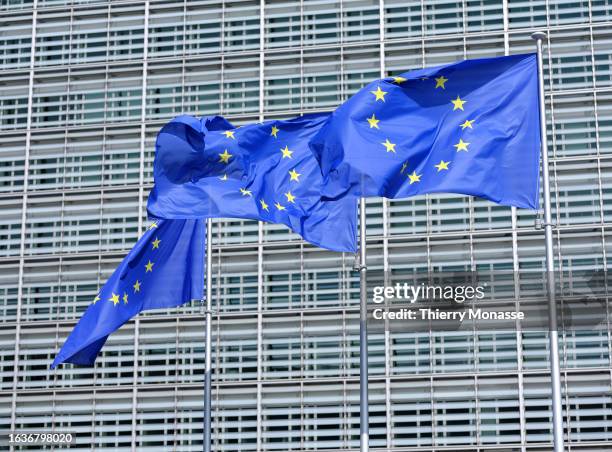 The flags of the European Union flutter in the winds in front of the Berlaymont, the EU Commission headquarter on August 31, 2023 in Brussels,...