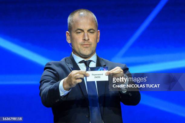 English former football player Joe Cole shows the paper slip of Feyenoord during the draw for the 2023/2024 UEFA Champions League football tournament...