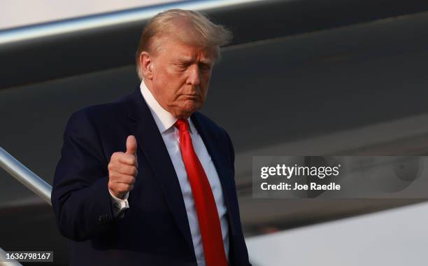 Former U.S. President Donald Trump gives a thumbs up as he arrives at Atlanta Hartsfield-Jackson International Airport on August 24, 2023 in Atlanta,...