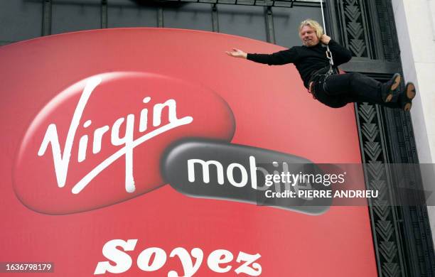 Richard Branson decends an abseil rope 03 April 2006 in Paris prior to a press conference for the launch of Virgin Mobile in Frence. Virgin Mobile...