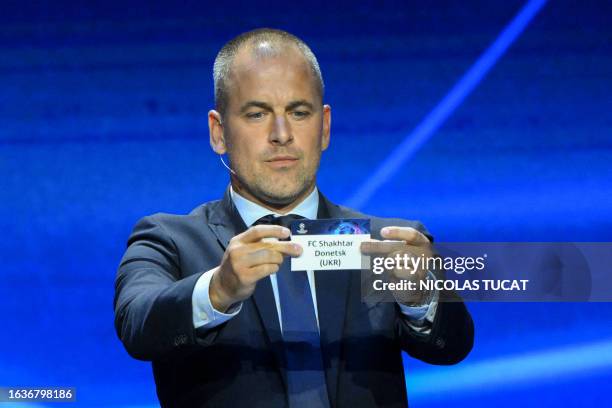 English former football player Joe Cole shows the paper slip of FC Shakhtar Donetsk during the draw for the 2023/2024 UEFA Champions League football...