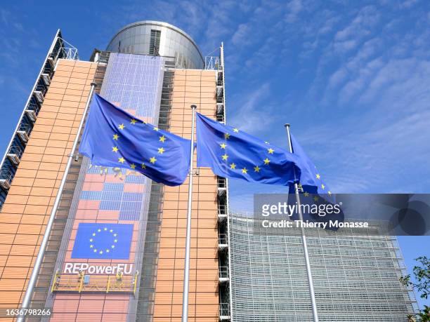 The flags of the European Union flutter in the winds in front of the Berlaymont, the EU Commission headquarter on August 31, 2023 in Brussels,...
