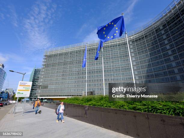 The flags of the European Union flutter in the winds in front of the Berlaymont, the EU Commission headquarter on August 31, 2023 in Brussels,...